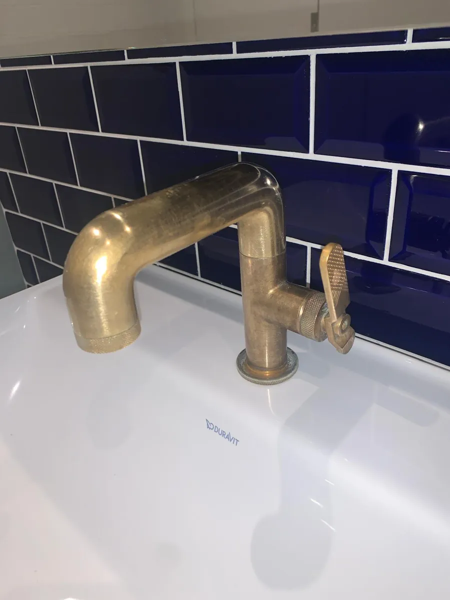 Spotless brass tap and basin, cleaned by Fresher Homes