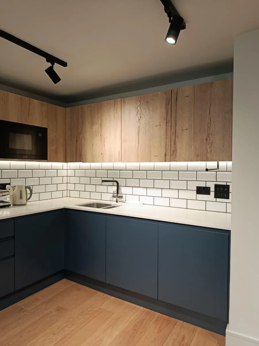 Deep-cleaned kitchen with track lighting in a London property